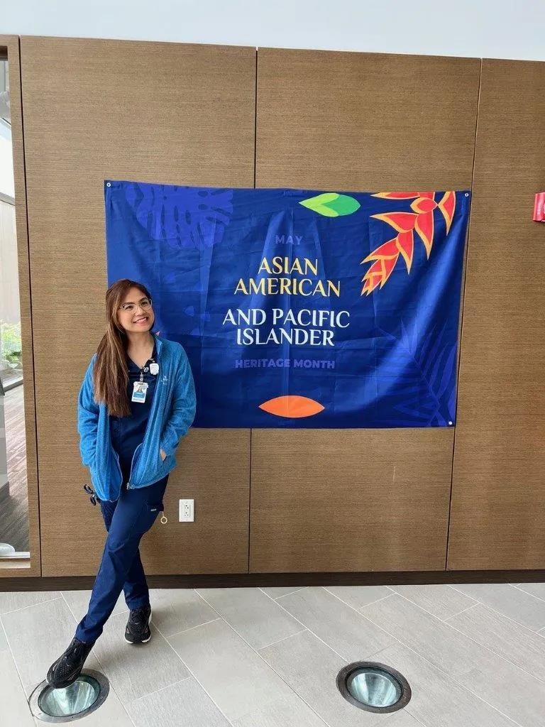 Woman in front of AAPI sign