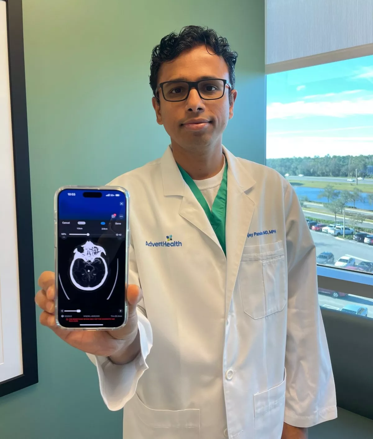 Dr. Vijay Pandav holding Viz.ai technology