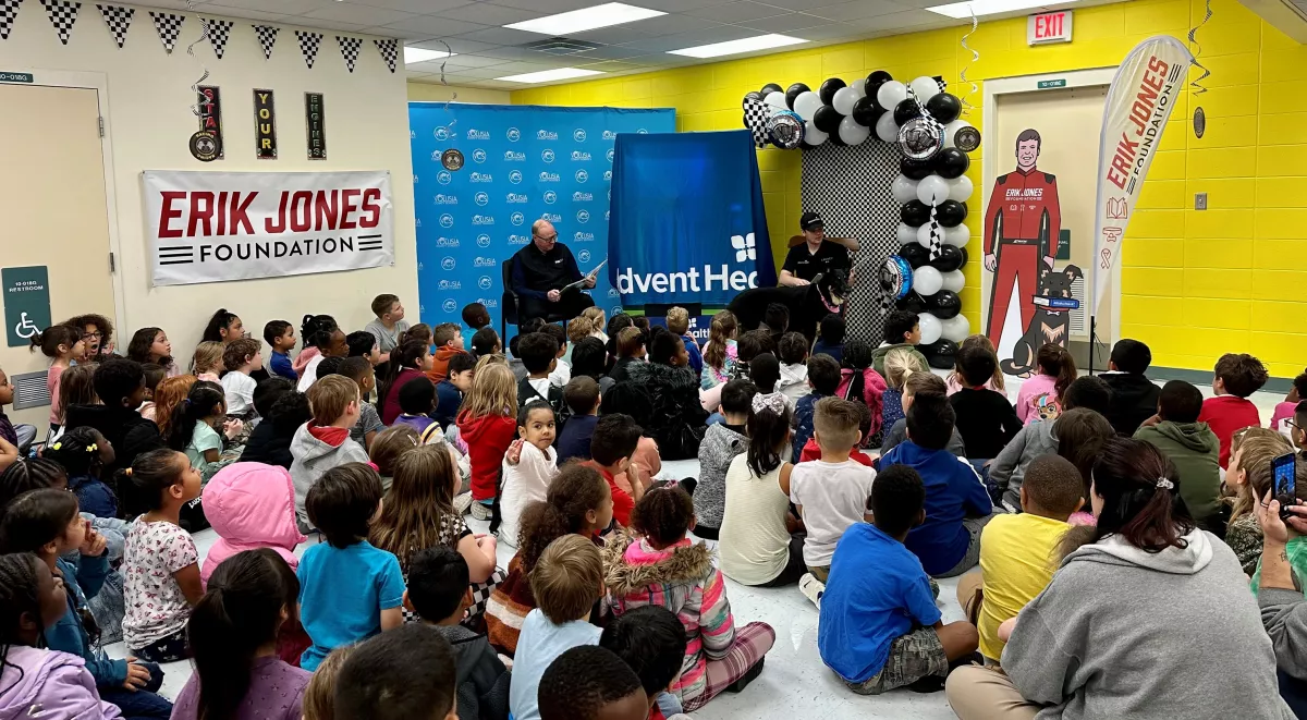 NASCAR Driver Reads to Children and Delivers a "Bookworm" Vending Machine to Local Elementary School