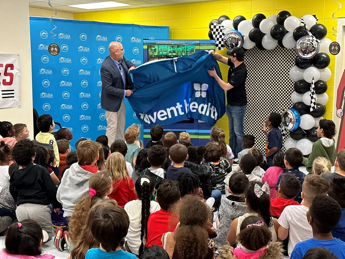 NASCAR Driver Reads to Children and Delivers a "Bookworm" Vending Machine to Local Elementary School