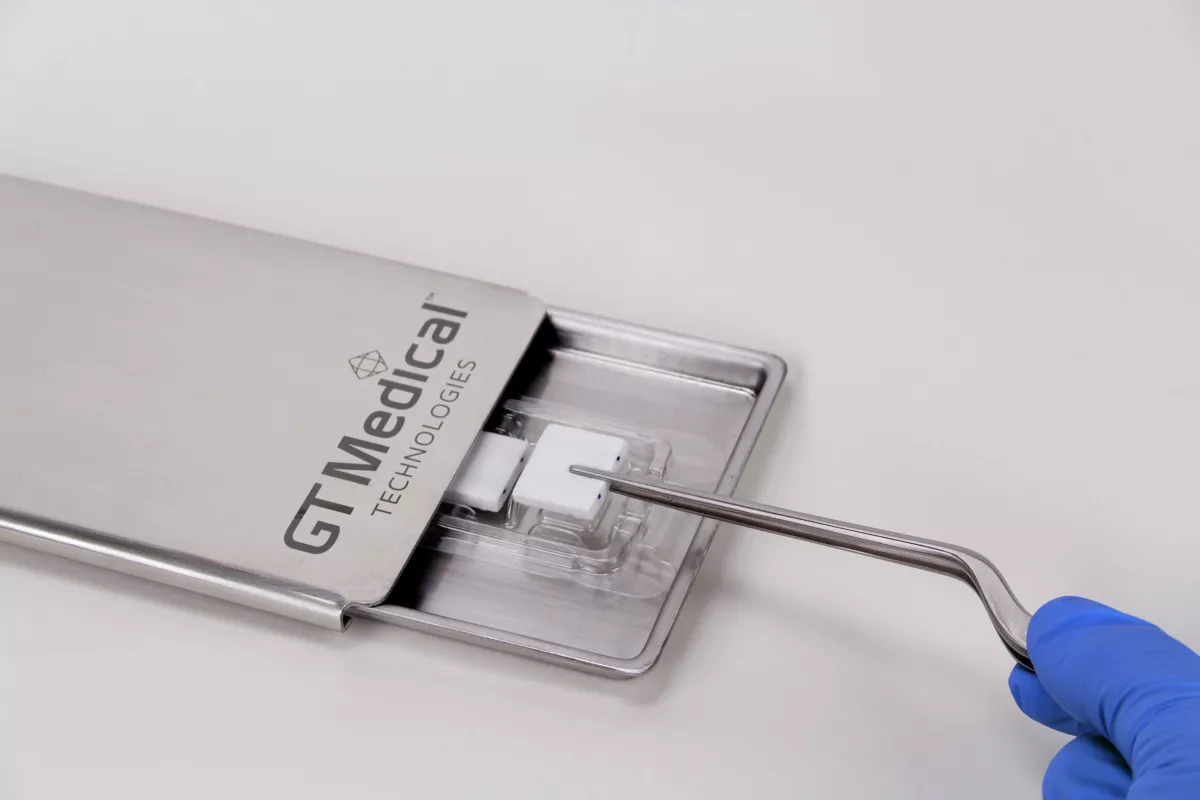 A piece of GammaTile being taken out from its tray.