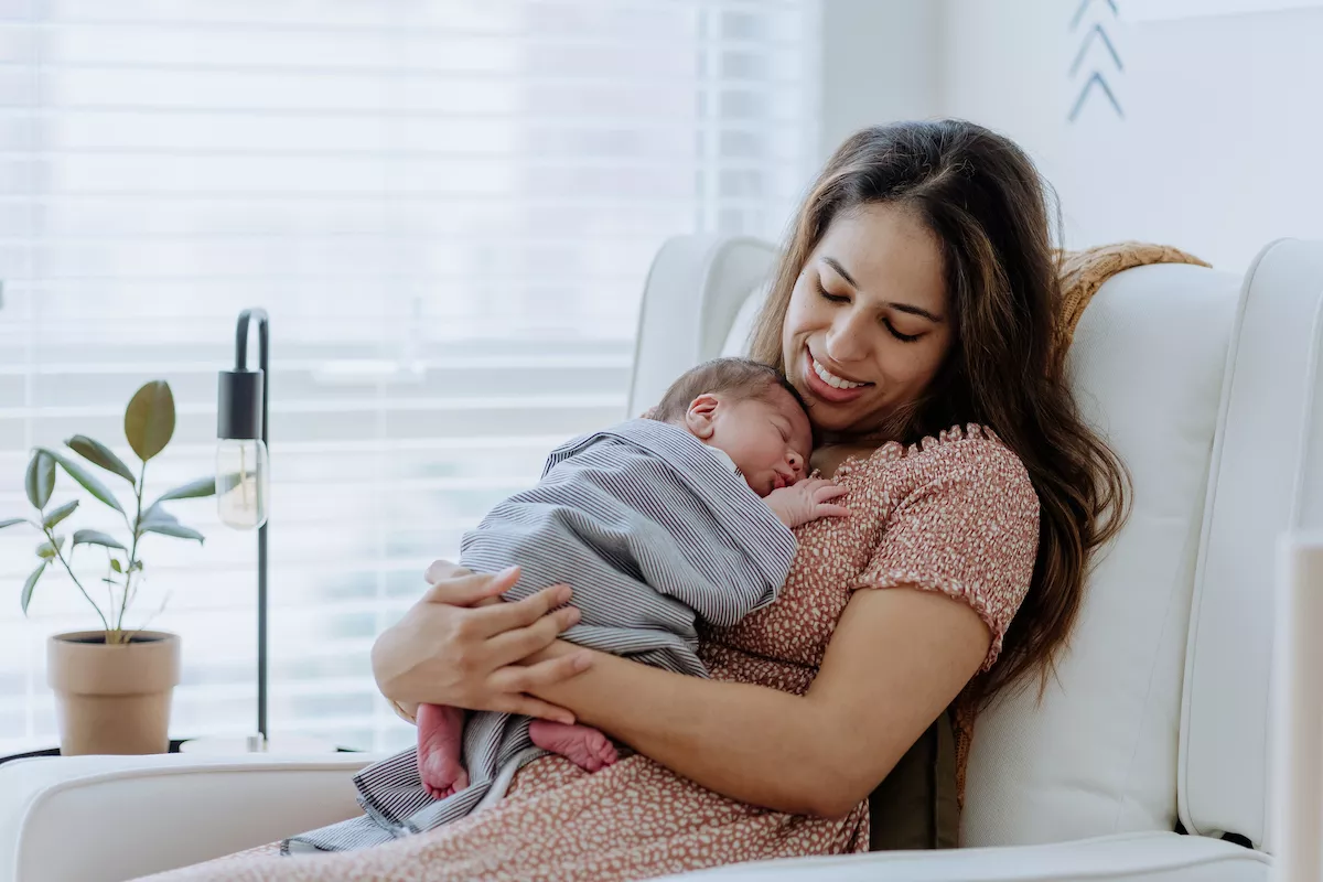 mother cuddles with new baby
