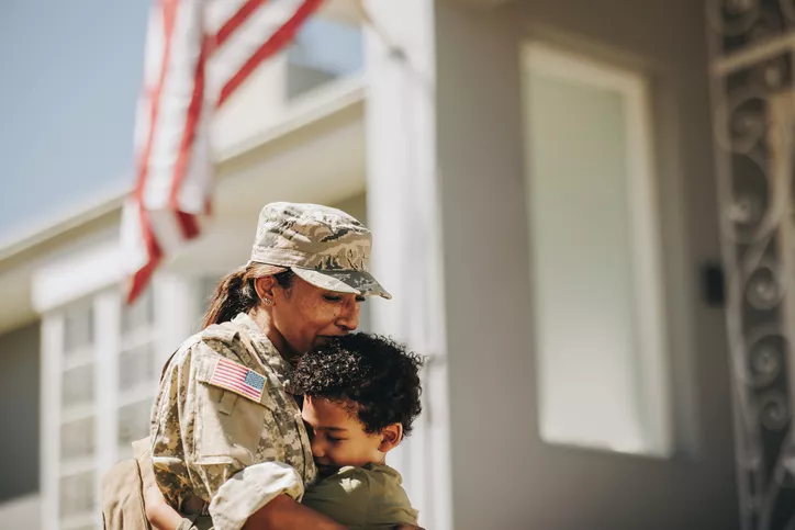 mother and veteran hugs son