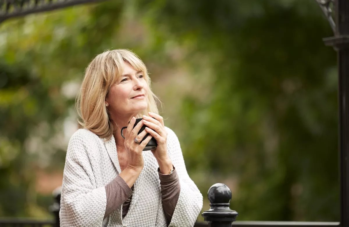 woman holding cup outdoors