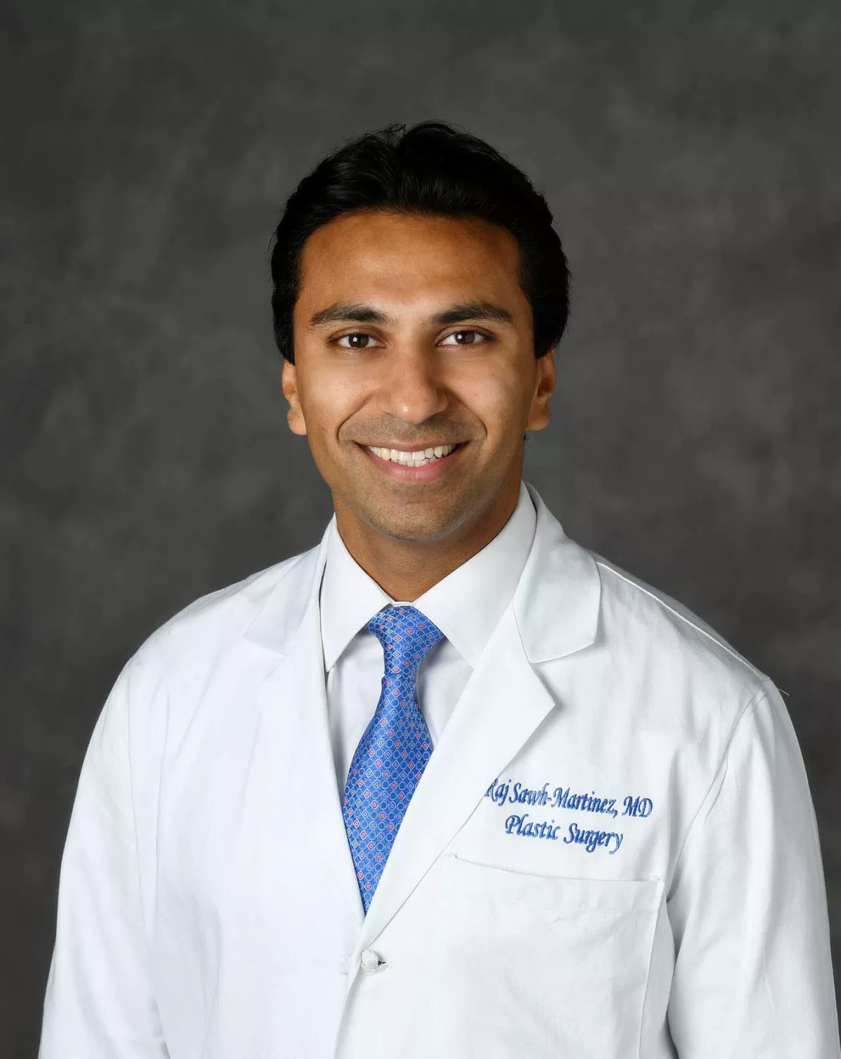 A professional headshot of Dr. Raj Martinez