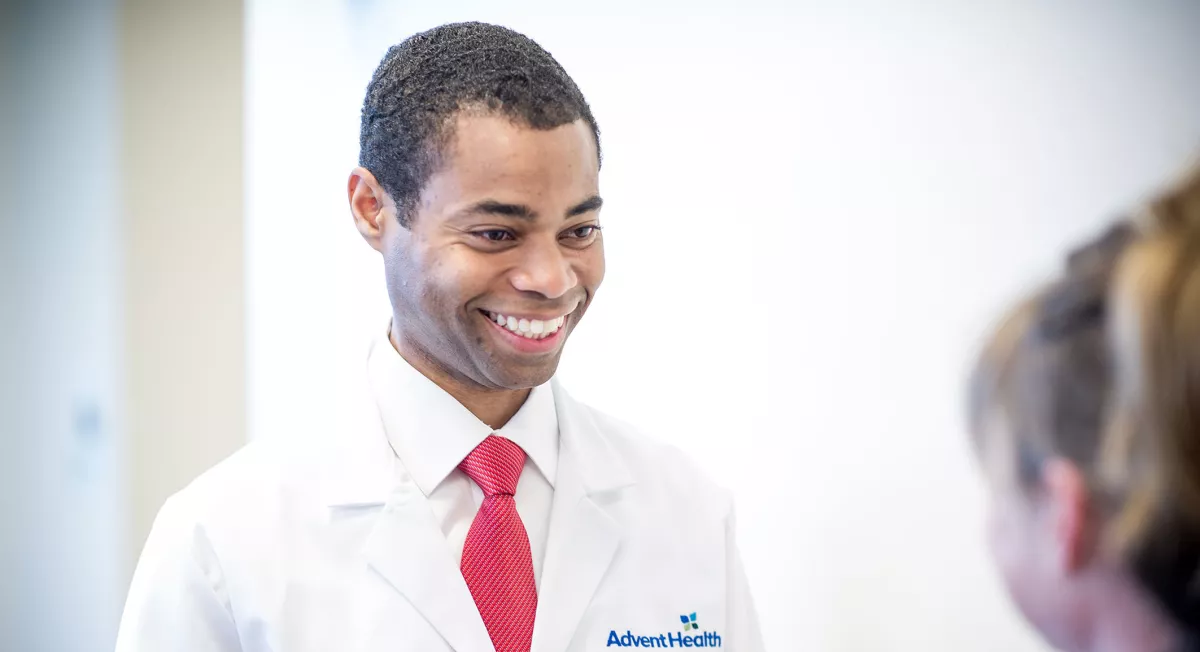 Doctor Carl Lokko smiling at a pediatric patient