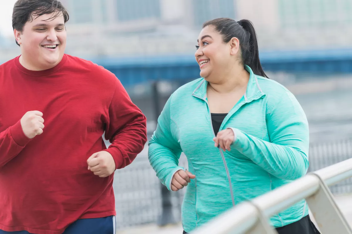 A couple goes for a jog together to improve their health.