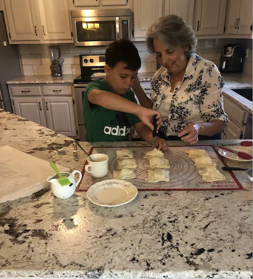 Sendros' mother making pastelitos with his son
