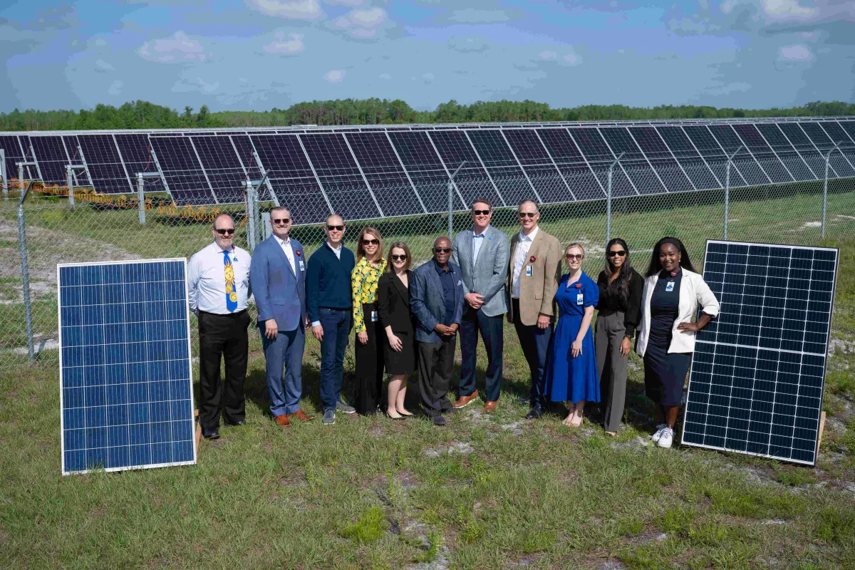 AdventHealth team members help cut the ribbon on OUC solar farm.