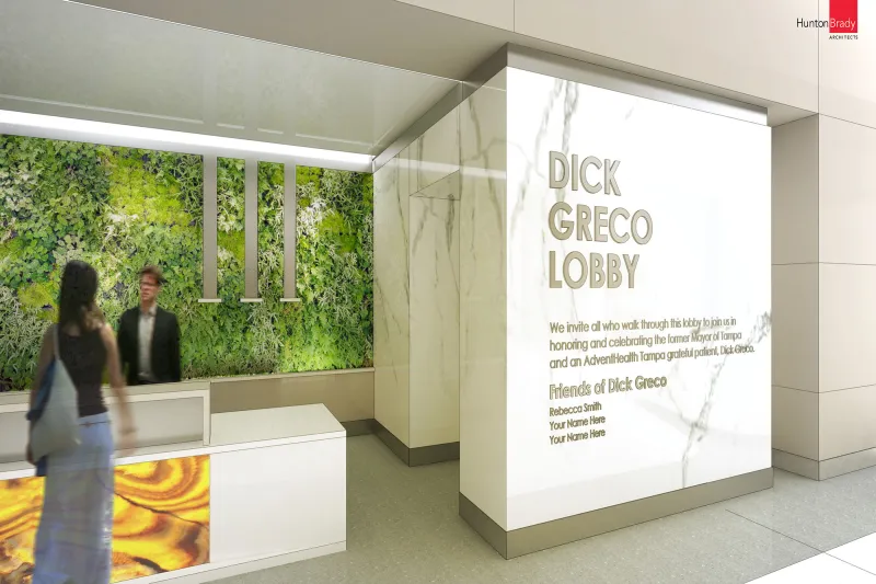 A lobby signage for Dick Greco etched on a marble column at The Taneja Center