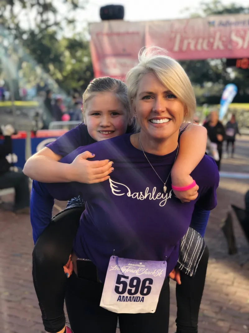 mother and daughter finishing AdventHealth Lady Track Shack 5k