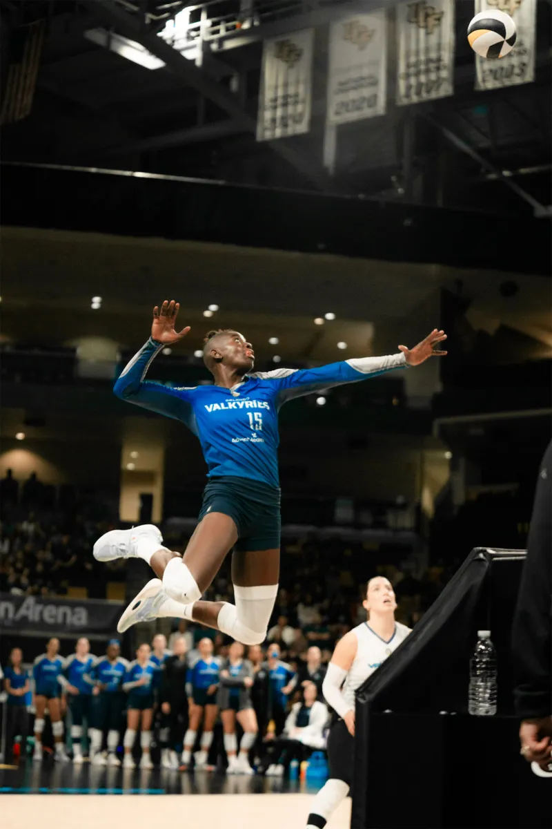 Orlando Valkyries player jumps into the air to hit a ball